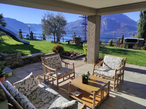 a patio with two chairs and a table with a view at Vezio Hill House in Perledo