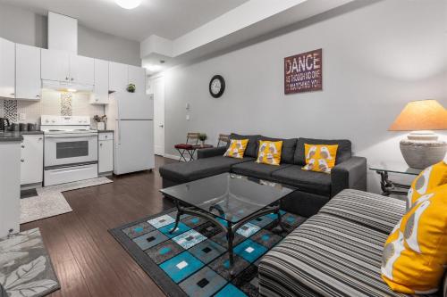 a living room with a couch and a table at Peaceful 2 Bedroom Suite that sleeps 4 with Free Wifi ,Free parking,easily accessible to Downtown Vancouver in Surrey