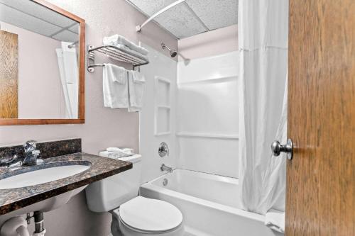 a bathroom with a sink and a toilet and a shower at Days Inn by Wyndham Sioux Falls in Sioux Falls