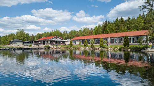 a large building next to a large body of water at Lakelodge in Karlskoga