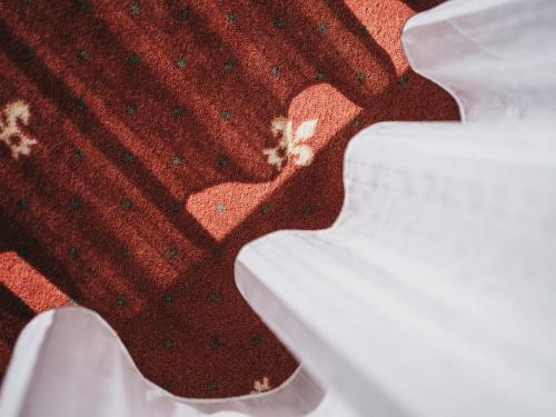 a close up of a red sweater with a white keyboard at Sporthotel Royer in Schladming