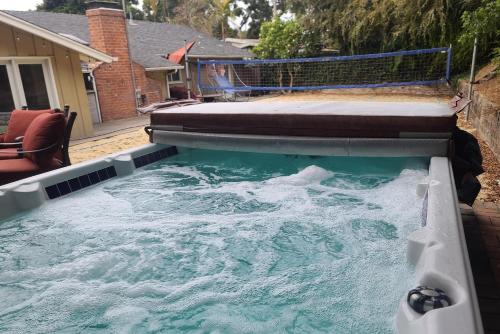 a pool of water with a mattress on top of it at Westside Retreat w Yard, Grill, Hot Tub, Near Sofi Stadium, LAX, and the Beach in Los Angeles