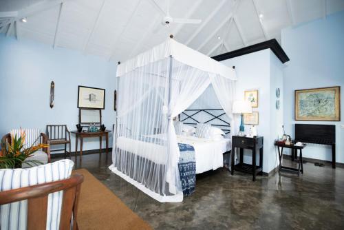 a bedroom with a bed with a canopy at Kahanda Kanda in Koggala
