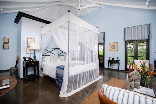 a bedroom with a bed with a canopy at Kahanda Kanda in Koggala