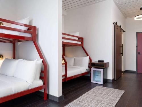 a room with two bunk beds and a table at Origin Kansas City Riverfront, a Wyndham Hotel in Kansas City