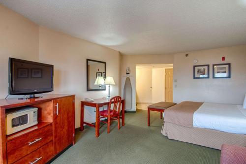 a hotel room with a bed and a television at Park Tower Inn in Pigeon Forge