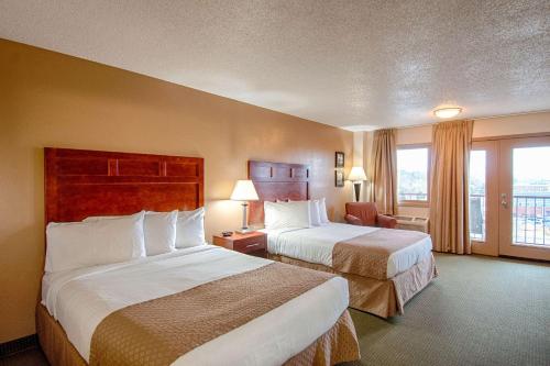 a hotel room with two beds and a window at Park Tower Inn in Pigeon Forge