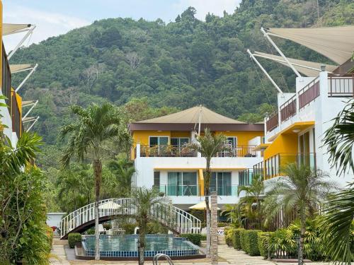 a resort with a mountain in the background at AP Grand Residence by Lofty in Kamala Beach
