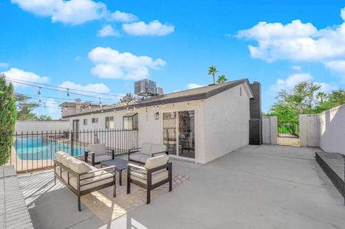 a patio with two chairs and a pool at Vegas Bliss near The Strip - Pet & Family Friendly in Las Vegas