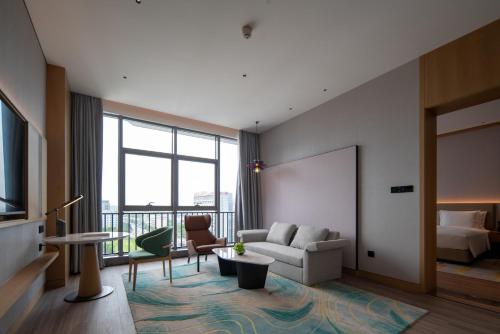a living room with a couch and a bed at Holiday Inn Guiyang Airport by IHG in Guiyang