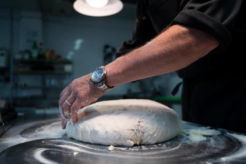 a person is kneading a dough on a wheel at Hotel Stella Della Versilia in Marina di Massa