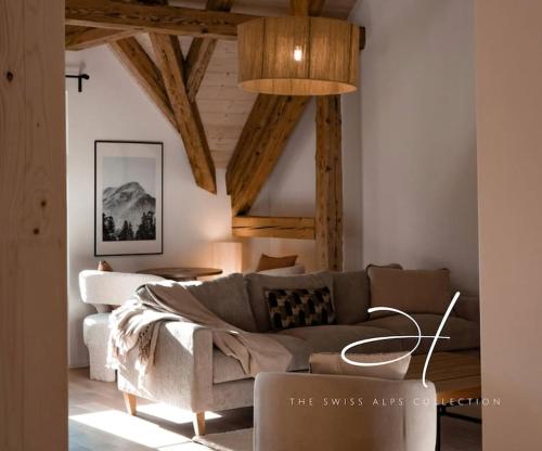 a living room with a couch and a table at Hidden Retreats The Alpstyle in Frutigen