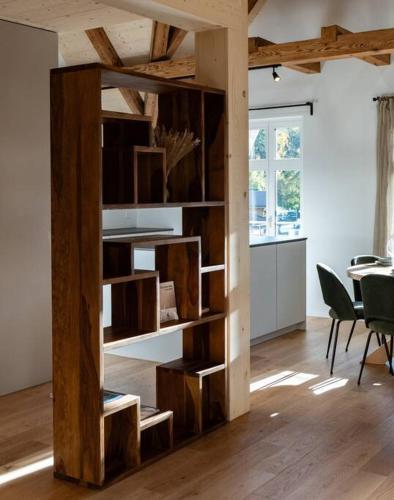 a book shelf in a living room with a table at Hidden Retreats The Alpstyle in Frutigen