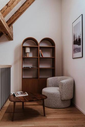 a living room with a chair and a coffee table at Hidden Retreats The Alpstyle in Frutigen