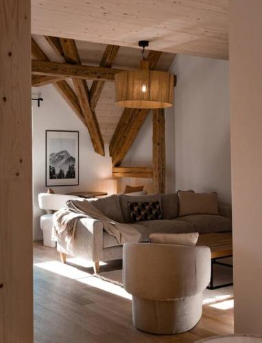 a living room with a couch and a table at Hidden Retreats The Alpstyle in Frutigen