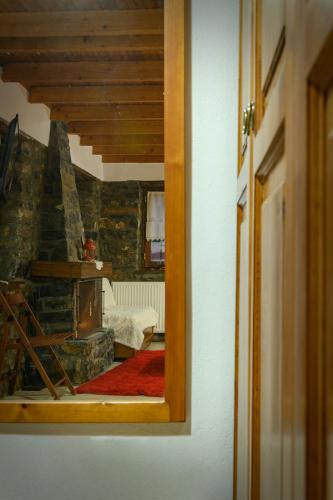 a view of a room with a bed and a mirror at Konaki inn in Palaios Agios Athanasios