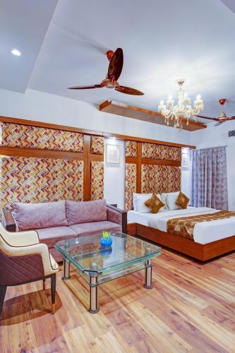 a living room with a couch and a bed at Hotel The Pearl, City Center - Traveler's Choice Award Winner for 2025 in New Delhi