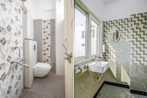 a bathroom with a toilet and a sink and a window at FabHotel Eminent Suites Banjara Hills - Nr LV Prasad Institute in Hyderabad