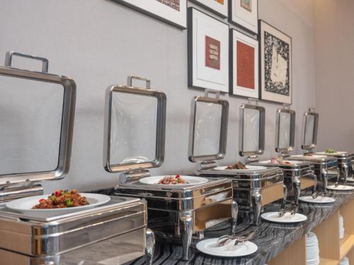 a row of sinks with plates of food at Holiday Inn Guiyang Airport by IHG in Guiyang