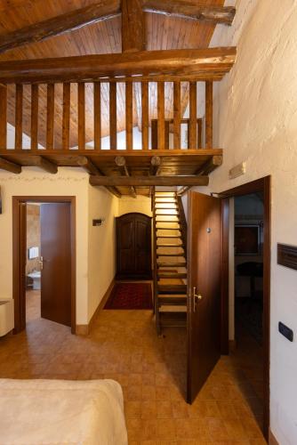a room with a wooden staircase in a house at AGRITURISMO RIPA DEL BOSCO in Capriolo