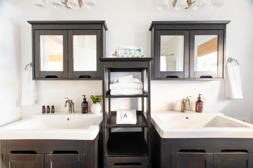 a bathroom with two sinks and two mirrors at Kokomo by AvantStay Bayside Getaway w Fire Pit Large Outdoor Patio in San Diego