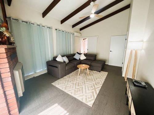 a living room with a couch and a table at Esperance Getaway in Esperance