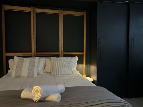 a bedroom with a bed with two towels on it at La Casetta, Garden Retreat in Cape Town