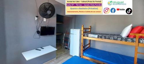 a dorm room with a bunk bed and a refrigerator at Arraial do Cabo – Subuai Village - Aluguel Econômico in Arraial do Cabo