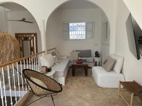 a living room with a couch and a chair at Dar Inès in Tangier