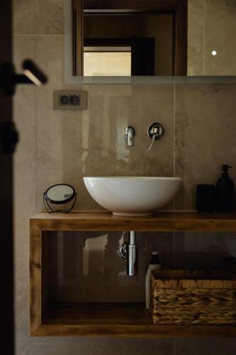 a bathroom with a white sink and a mirror at Luxury Villa Pearl 1 with infinity pool in Baška