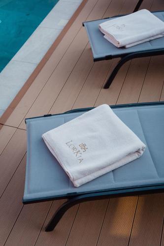 two tables with towels sitting on top of them at Luxury Villa Pearl 2 with infinity pool in Baška