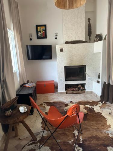 a living room with a chair and a fireplace at Dar Inès in Tangier