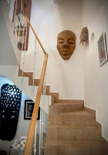 a staircase with a mask on the wall at Dar Inès in Tangier