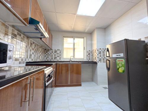 Kuchyň nebo kuchyňský kout v ubytování Barsha Star Residence 2-HomeStay