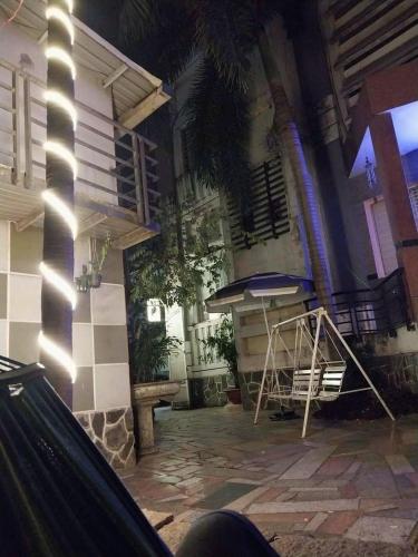 a patio with a table and a bench in front of a building at Khách Sạn Khánh Du - Khanh Du Hotel in Bien Hoa