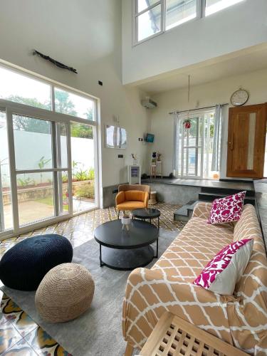 a living room with a couch and a table at Six Boutique Collection in Mannārgudi