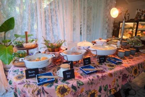 a table with bowls of food on a floral table cloth at Blu Monkey Pooltara Krabi Hotel & Villas Pet Friendly in Tha Lane Bay
