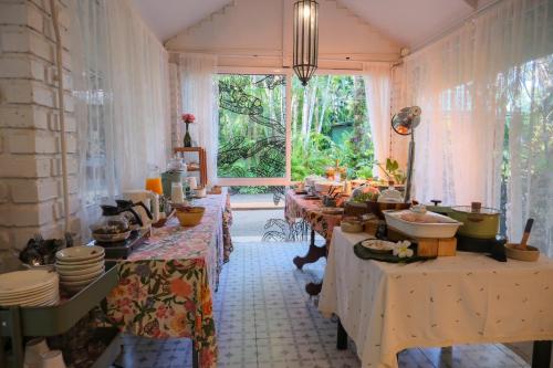 a room with many tables and a large window at Blu Monkey Pooltara Krabi Hotel & Villas Pet Friendly in Tha Lane Bay