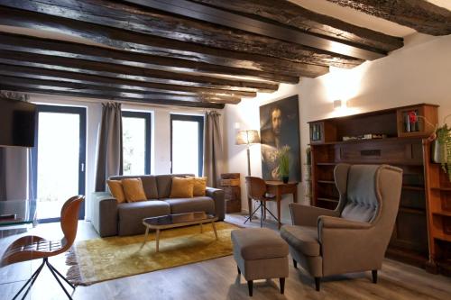 a living room with a couch and two chairs at Villa Delange in Landau in der Pfalz