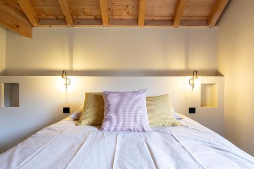 a bedroom with a bed with two lights on it at Chalet Rossanaz in La Motte-en-Beauges