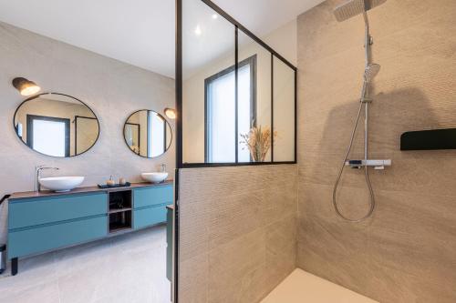 a bathroom with two sinks and a shower at Chalet Rossanaz in La Motte-en-Beauges