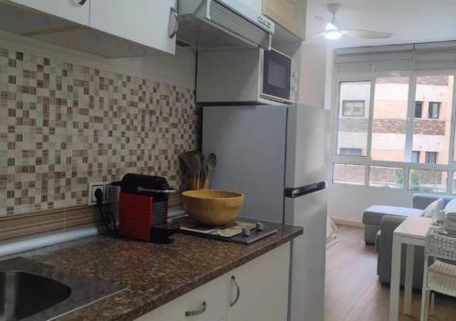 a kitchen with a refrigerator and a bowl on a counter at Estudio Pastora in Torremolinos
