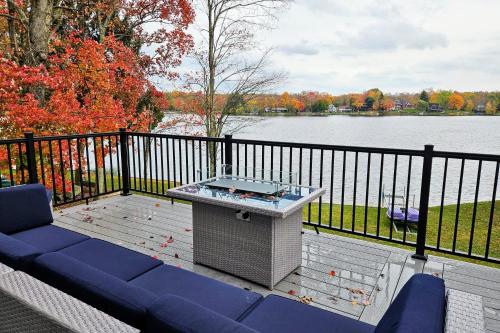 a bench on a deck with a view of a lake at Lakeside Serenity by AvantStay Lakefront Newly Built Deck w Views in White Haven