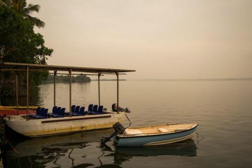 a boat with blue seats on the water at New Saniro Lagoon Deck in Katunayaka
