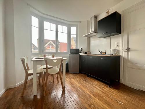 - une cuisine avec une table, une table et des chaises dans l'établissement Appartement centre-ville 2 personnes, à Troyes