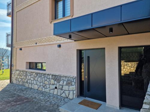 a building with a door and a stone wall at Villa Libero in Sarajevo