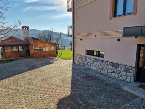 a building with a stone walkway next to a building at Villa Libero in Sarajevo