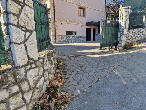 a stone wall with a gate on a street at Villa Libero in Sarajevo