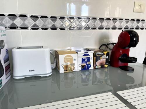 a counter top with a toaster and a coffee maker at Apartamento 3 habitaciones en Plaza de España 6PAX in Vigo