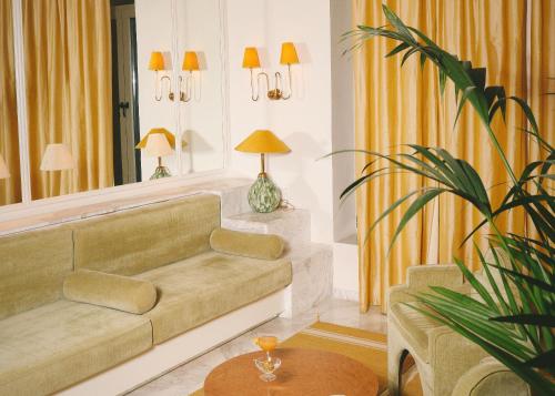 a living room with a couch and a table at Apollo Palm Hotel in Athens